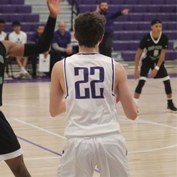 Senior Jack Simanek in the middle of a basketball game.