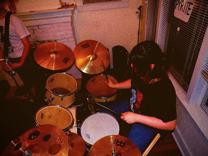 Junior Thomas Rodriguez shown drumming at a house show.
