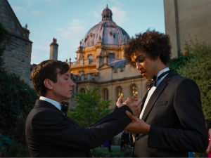  Farleigh (Archie Madekwe) comments on Oliver Quicks (Barry Keoghan) long suit sleeves during a scene at the Oxford Ball.