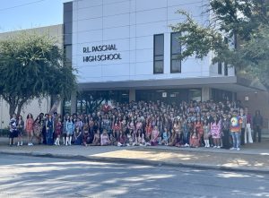 The Class of '25 Seniors pose in front of the school for Paschal's annual Senior Polyester photo. 