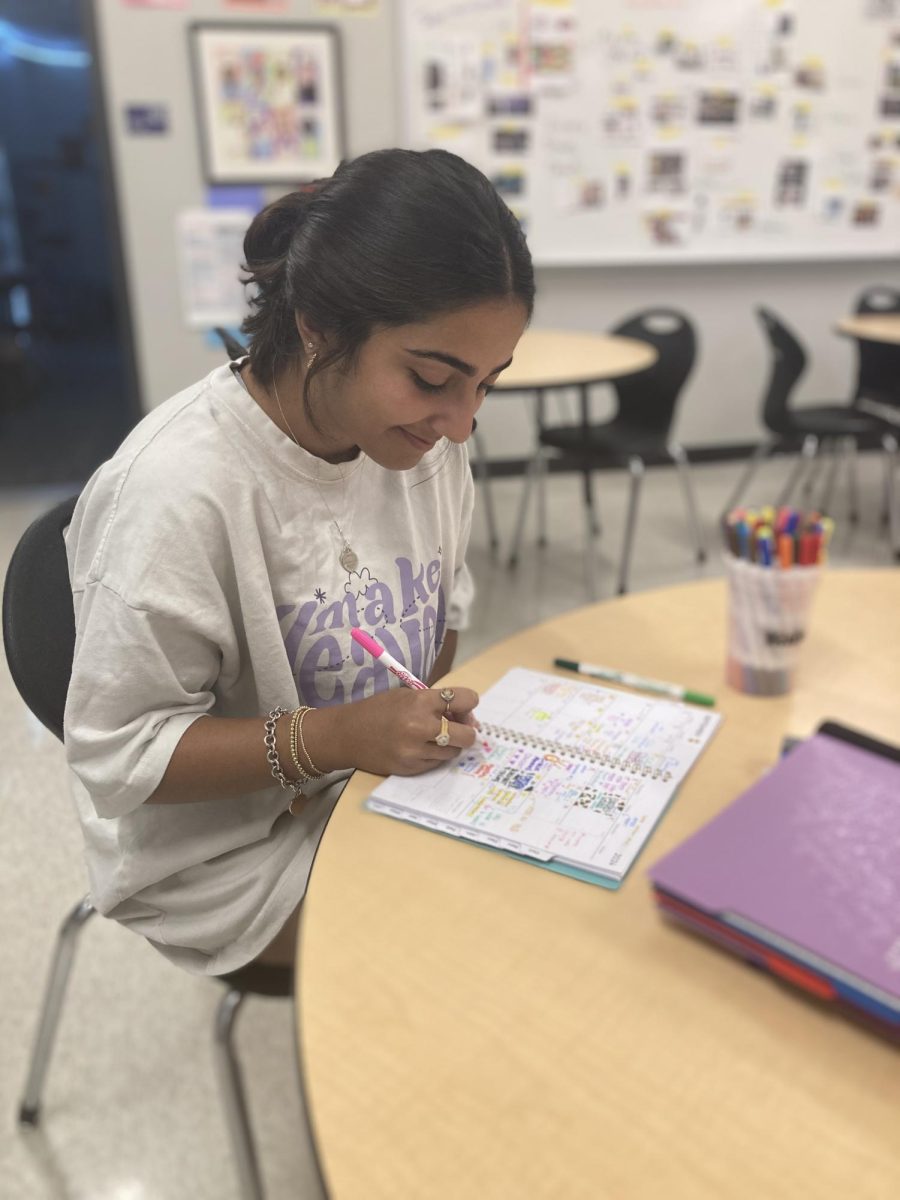 Hedaya Abdul Karim (12) updates her planner for the month of September. 