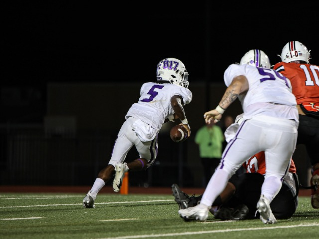 Jashaun Thomas (11) scrambles away from the defensive pressure at the game against Irving MacArthur. 