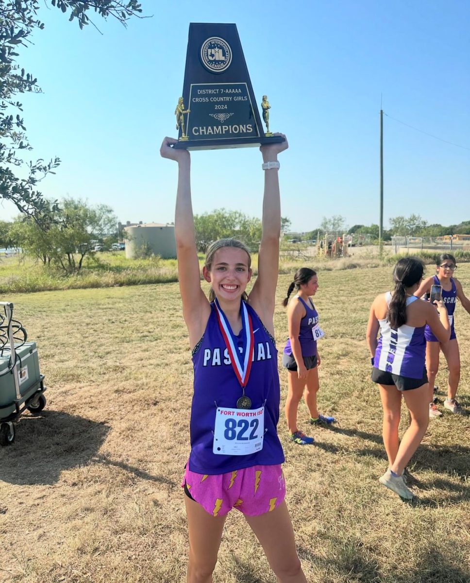 Madison Ledbetter (12) holds the girls team's district champions trophy. She got an amazing personal record of 19:15 at this meet! (Photo provided by Madison Ledbetter)