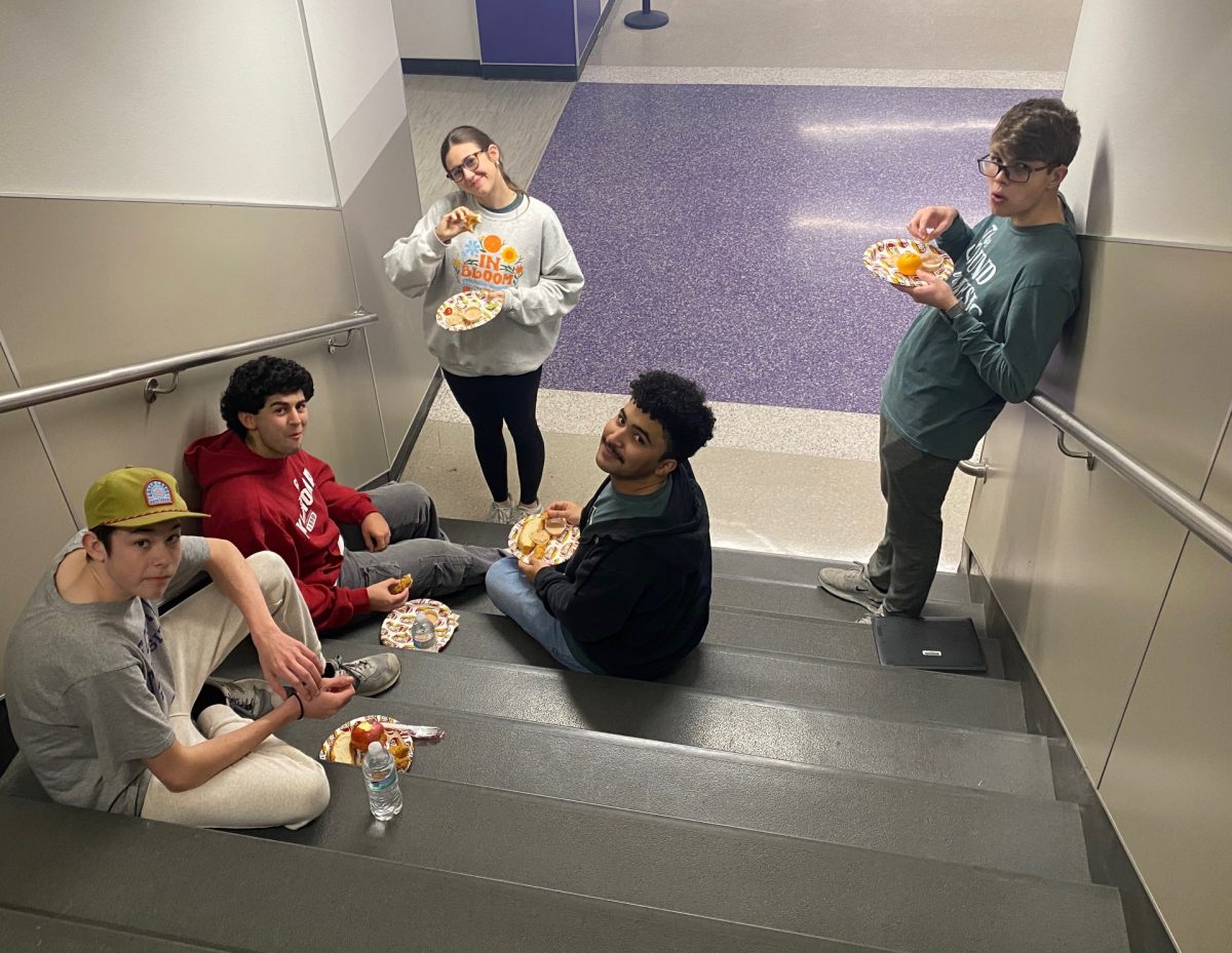 Several cast-members enjoy dinner outside the auditorium before the start of a long rehearsal.