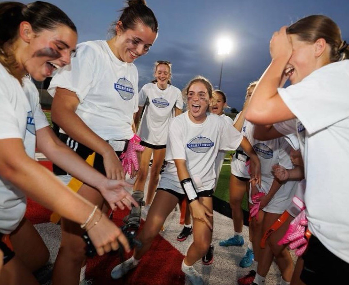 The girls flag football team celebrates their win